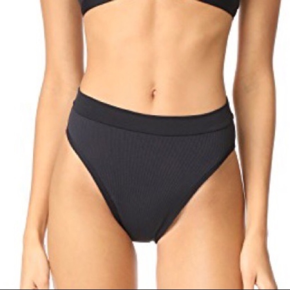 L SPACE French cut high waisted bottom in black ripped. Size M